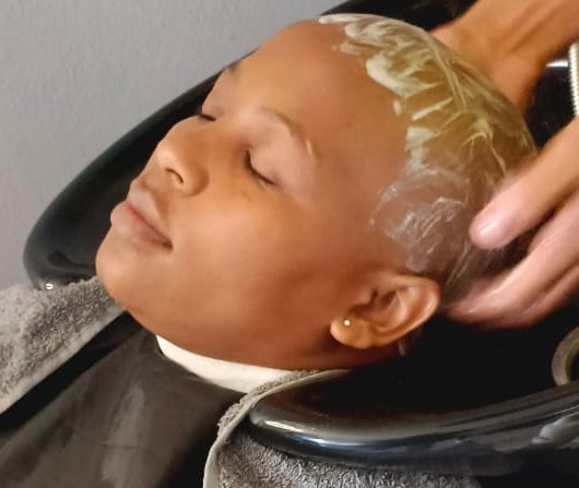 Client receiving a hair wash and treatment